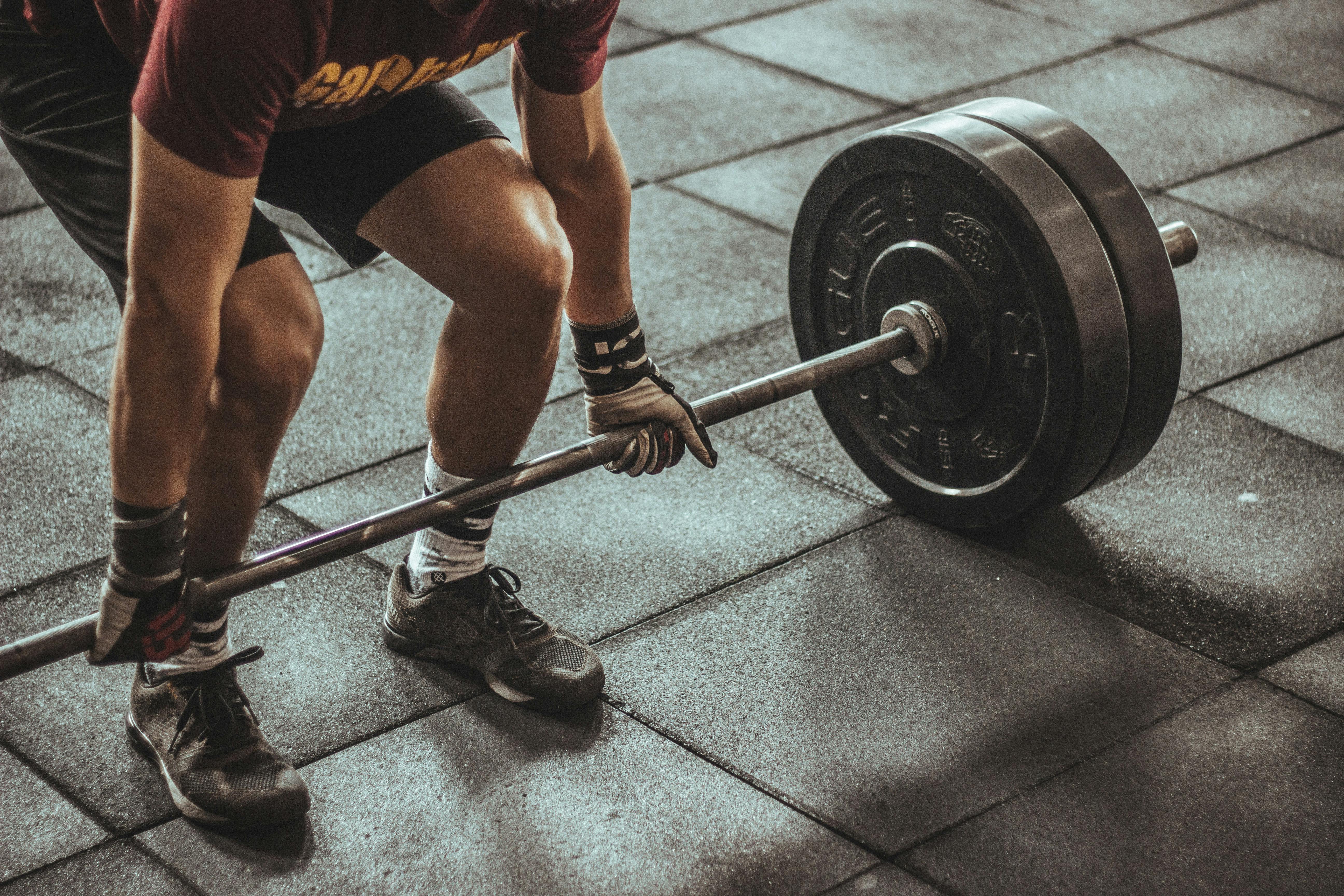 Intense weightlifting training - person preparing for deadlift